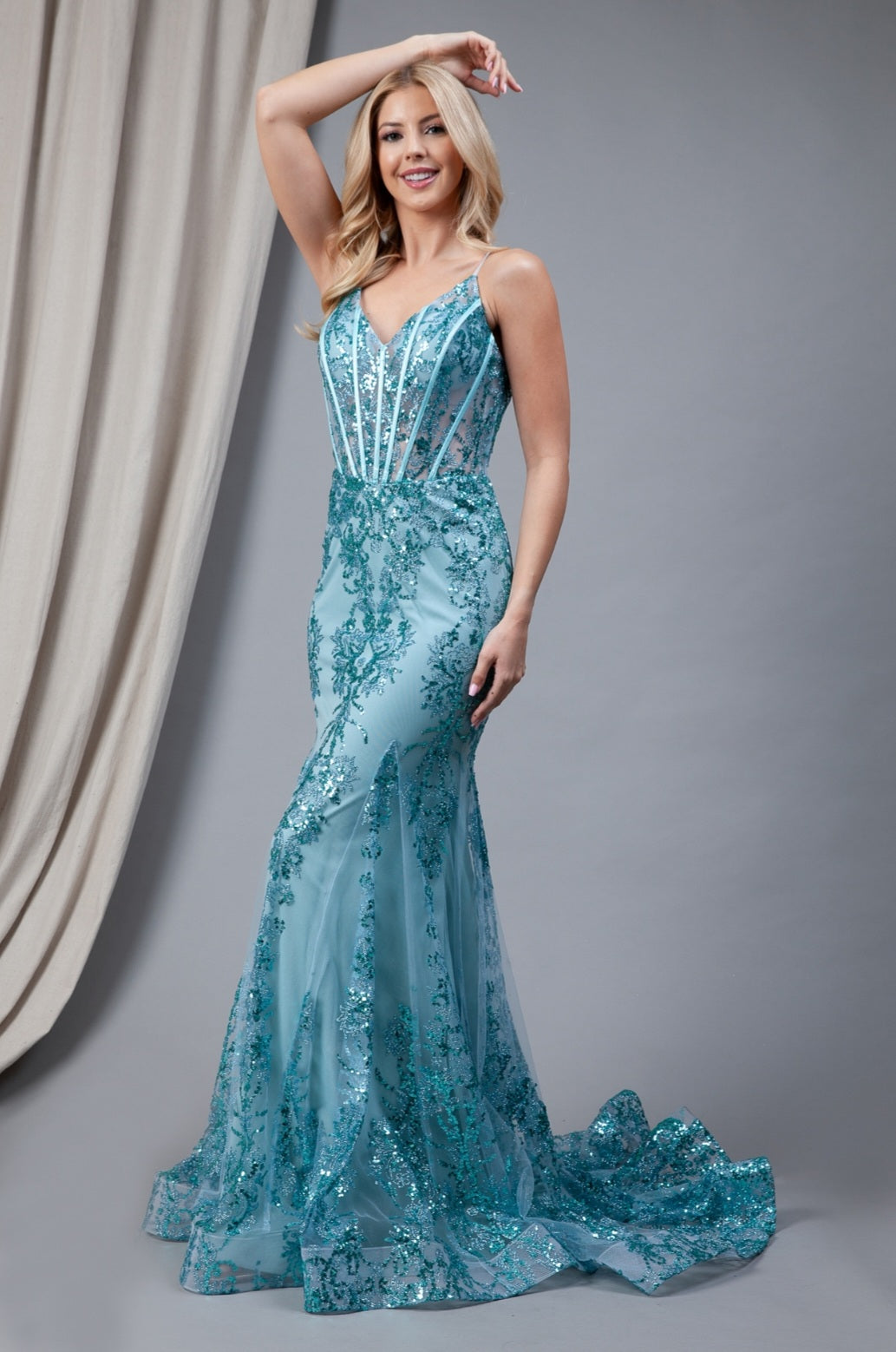 Gown features a sweetheart neckline, spaghetti straps and a V-back